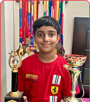 Hridhan Sharma holding trophies and medals
