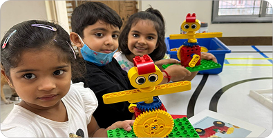 Young Robominds students building with colourful robotics blocks