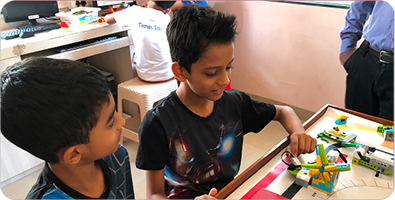 Two boys working together on a robotics build at the new Baner centre